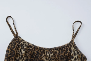 Detail of leopard print bodysuit neckline with delicate ruching and spaghetti straps