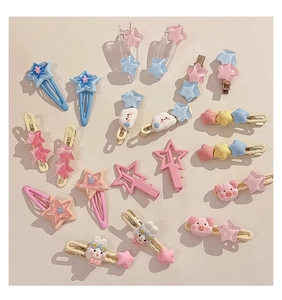 Flat lay of colorful Y2K hair clips including star, cloud, and rabbit shapes in pastel tones