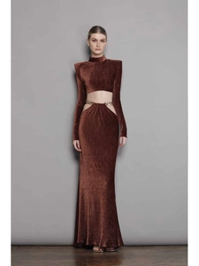 Detail of dark brown velvet two-piece set with waist cutout and gold chain ornament