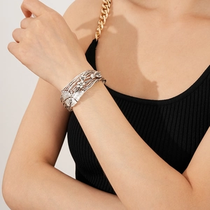 Close-up of vintage hollow butterfly and flower open bangle with brushed silver finish