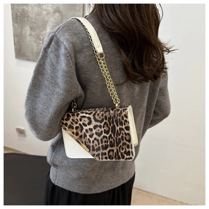 Detail shot of leopard print patchwork shoulder bag with elegant gold chain strap