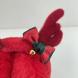 Red Christmas earmuffs with plush fur, festive ribbon bows and golden bells