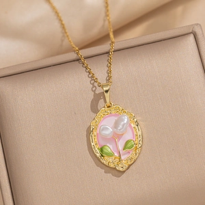 Baroque pearl pendant with pink enamel flowers on a gold chain in jewelry box