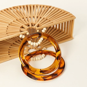 Handcrafted semicircular hollow bamboo handbag with amber resin handles for women