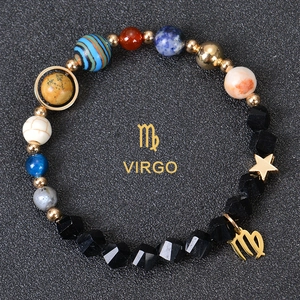 Detailed close-up of faceted obsidian beads with Virgo zodiac symbol and golden star charm