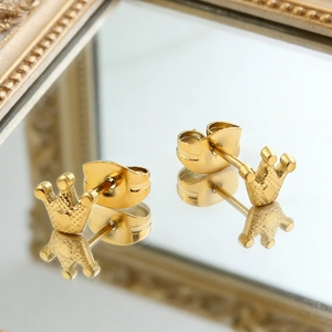 Minimalist crown stud earrings in gold finish with butterfly backs on mirror