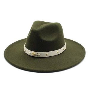 Macro detail of dark green wool fedora hat with white studded leather band
