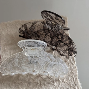 Lace pattern medium hair claw clips in black and white styles on minimalist paper