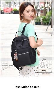 Close-up of black Oxford cloth backpack featuring silver zippers and bear charm