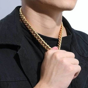 Close-up of a 12mm gold plated Cuban link chain necklace worn on a model's neck
