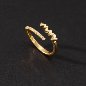 Detail of gold open ring with interconnected hearts and sparkling zircon pave accents