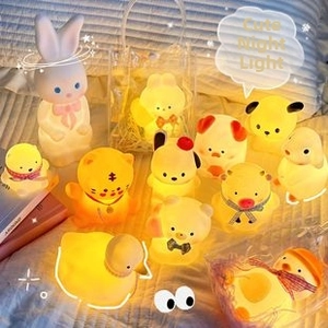 Close-up of various cute animal night lights including rabbits and bears on bedding