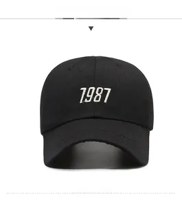 Front view of black baseball cap featuring 1987 white numeric embroidery and curved brim