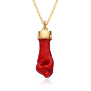 Golden necklace featuring a polished red fist-shaped natural stone pendant on white background