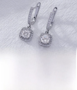 Macro shot of silver ear hooks with white zircons and detailed pavé diamond setting