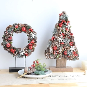 Christmas pinecone wreath and tree set with red berries and snow-dusted pine needles