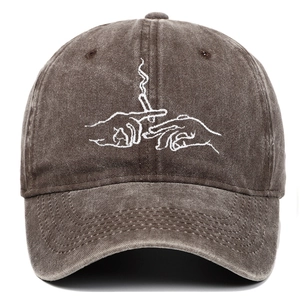 Close-up of vintage washed charcoal baseball cap featuring artistic hand embroidery