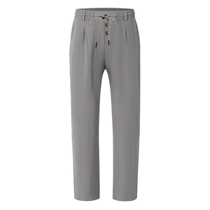 Detail of grey breathable linen-style trousers featuring drawstring elastic waist and button fly