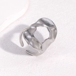Minimalist silver open ring with irregular lava texture and polished metallic finish