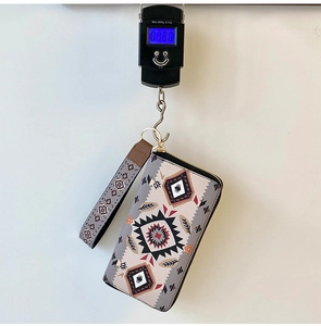 Detailed view of 180g lightweight ethnic patterned wallet being weighed on a scale