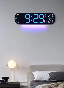 Modern LED digital wall clock with blue display and purple ambient light on bedroom wall