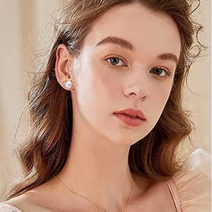 Elegant gold reindeer antler earrings with blue crystals shown on a female model