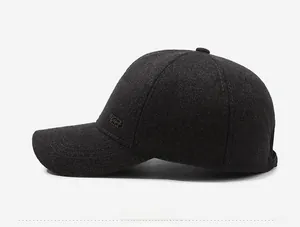 Detailed side view showing charcoal grey wool texture and metal logo of the winter baseball cap