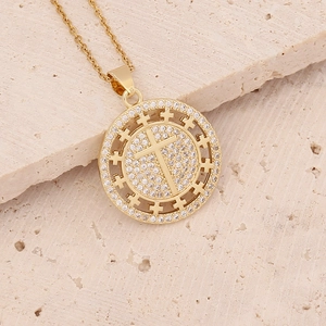 Macro shot of 18K gold plated cross pendant with micro-pave cubic zirconia crystals