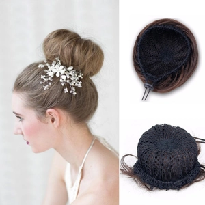Detail view of dark brown hair bun showing lace base, drawstring and clip-in attachment