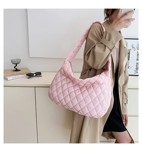 Detail of pink quilted nylon cloud bag featuring lightweight pleated large capacity design