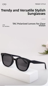 Detail of polarized cat-eye sunglasses with thick black frames on a geometric display