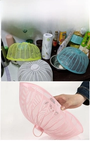 Macro shot of colorful plastic mesh food covers with leaf patterns and top handles