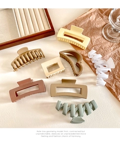 Collection of matte resin hair claws in soft earth tones and geometric shapes