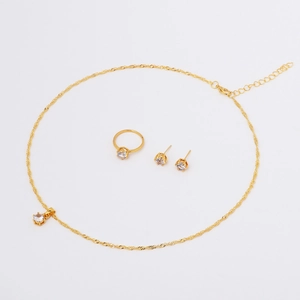 Detailed view of golden jewelry set featuring clear round zircon stones and water wave chain
