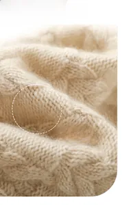 Macro shot of warm beige cable knit wool texture with soft fluffy cashmere fibers