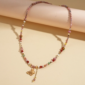 Close-up of colorful beaded necklace with a golden butterfly pendant and metal chain