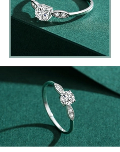 Detailed macro view of silver ring with leaf-shaped side stones and a round center zircon