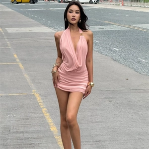 Detail of pink halter neck mini dress with gold buckle accents and pleated fabric design
