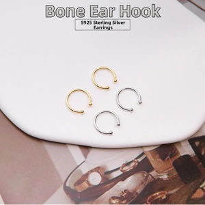 Detailed view of S925 sterling silver ear cuffs in gold and silver set on white board