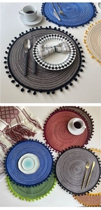 Close-up of woven coasters with colorful pompoms and textured material detail