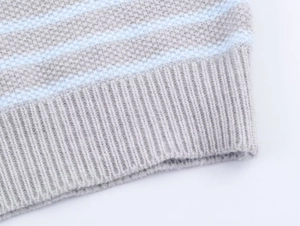 Detail of grey and light blue striped knit vest showing fine ribbed hem and texture