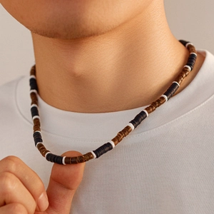 Men's bohemian coconut shell beaded necklace with black, brown, and white cylinder beads