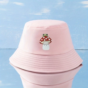 Pink bucket hat featuring cute frog and mushroom embroidery with a mirrored reflection