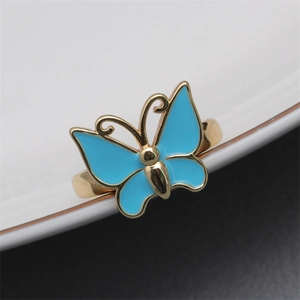 Close-up of sky blue butterfly adjustable copper ring with golden finish details