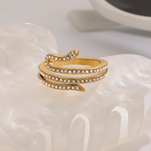 Detailed macro shot of a gold snake ring encrusted with sparkling white rhinestones