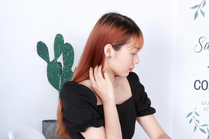 Close-up of minimalist round hollow rhinestone stud earrings worn on a female ear