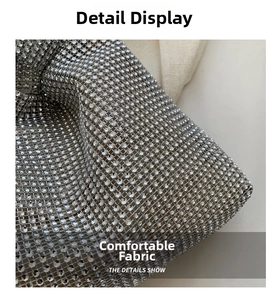 Close-up of sparkling silver rhinestone mesh fabric with high-density inlay detail