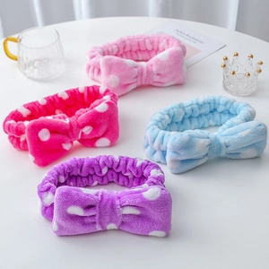 Detailed view of four colorful polka dot coral fleece headbands for face washing
