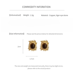 Detail info showing 2.3g weight and tiger eye stone dimensions on gold textured earrings