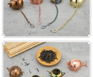 Detailed view of teapot-shaped stainless steel tea strainers in four metallic finishes